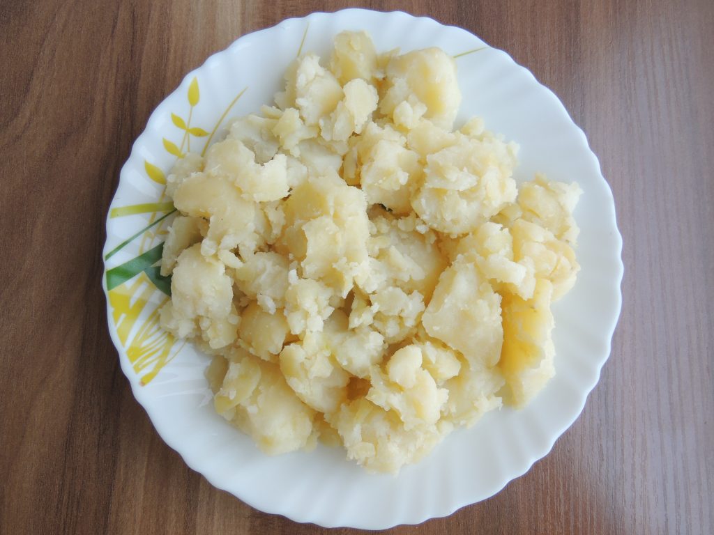 Peel off potato, mash potato by hand only.