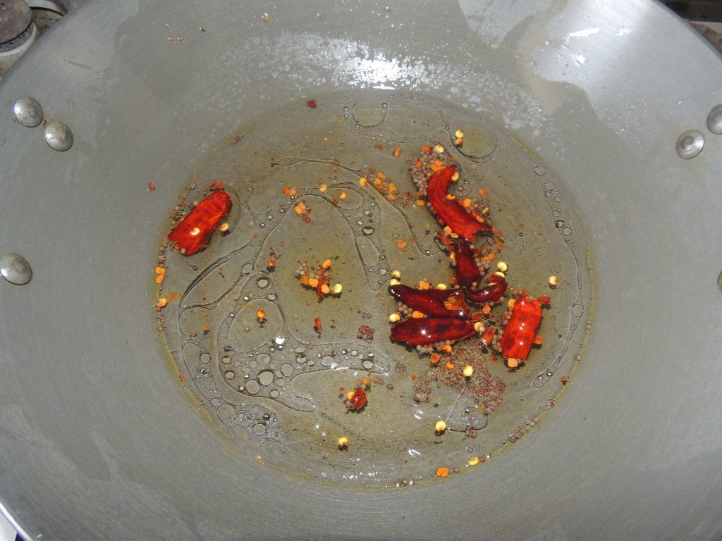 After that add pinch of asafoetida in the kadai. Once spices stared crackling. Add 1 cup of water into the kadai.