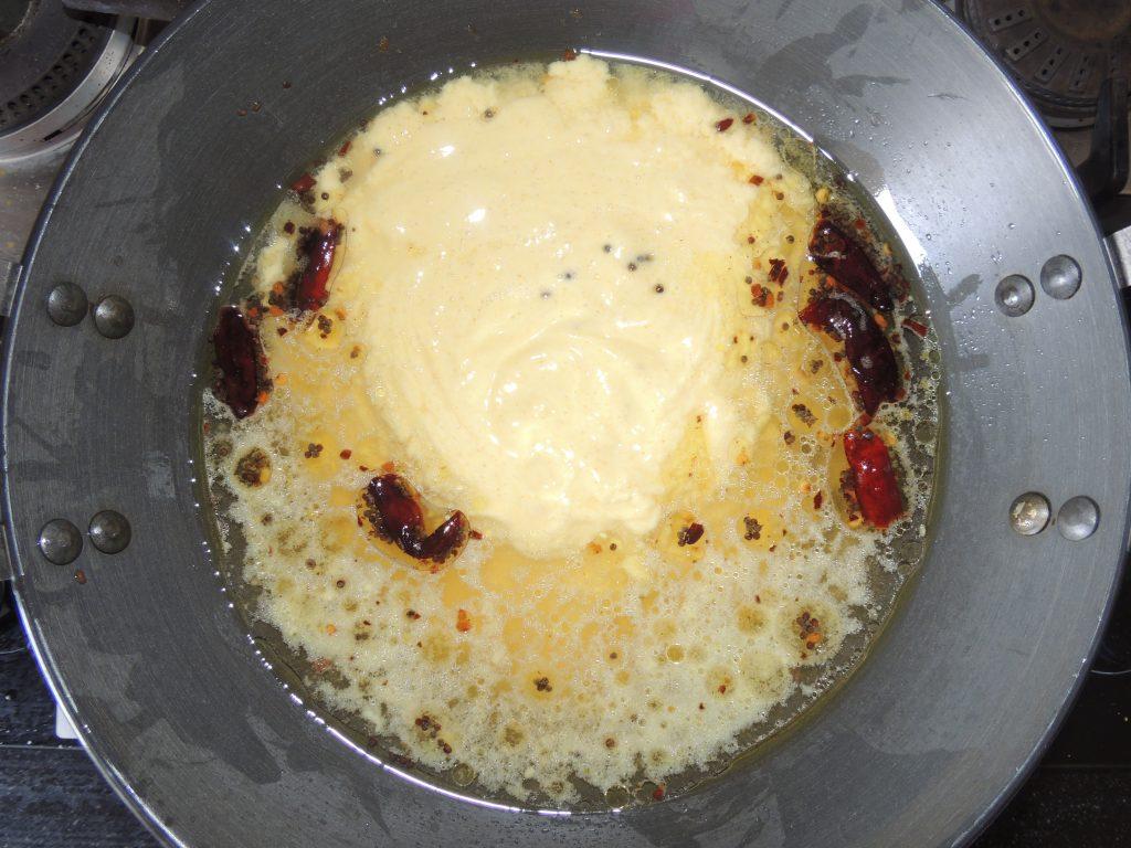 After that add the mixture of curd and gram flour / besan in the kadai.