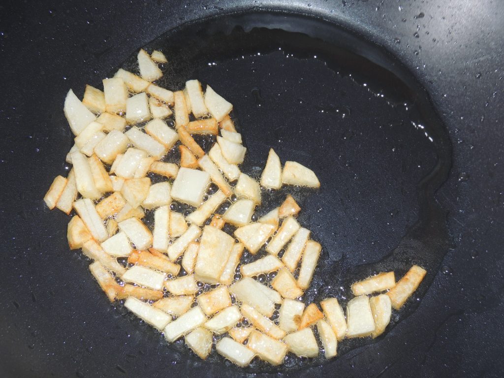 Stir and fry the potatoes with spatula.