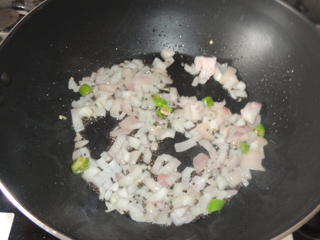 After that add chopped onion in the kadai.