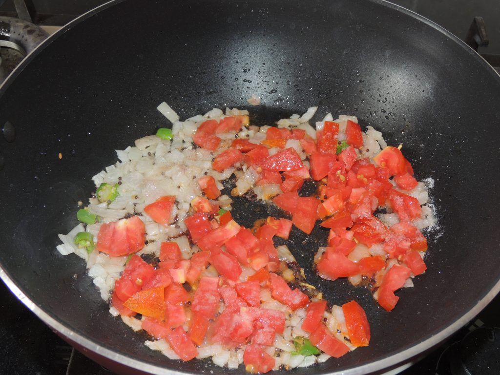 Once onion become brown, add chopped tomato in the kadai.
