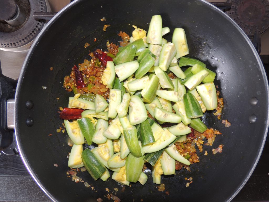 Then add chopped pointed gourd / parwal to the spices.