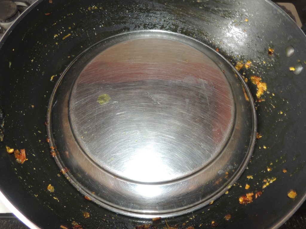 Mix spices to the vegetable and close the lid of kadai / fry pan.
