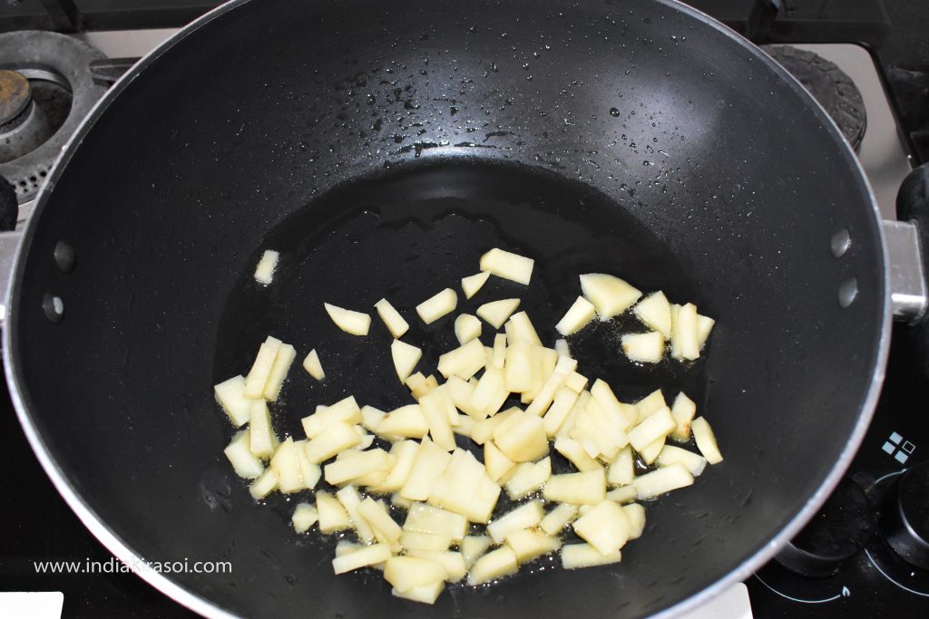 Now add chopped potatoes in the oil left in the kadai / pan.