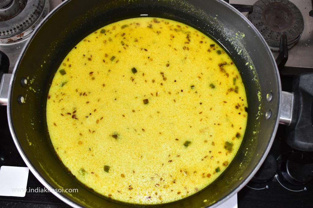 Stir the curd till the stock starts boiling.