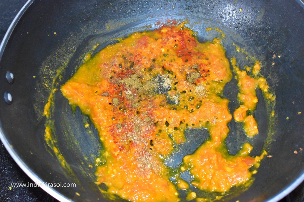 When tomatoes are cooked, add half teaspoon coriander powder, half teaspoon red chilli powder and 1/4 teaspoon garam masala powder.