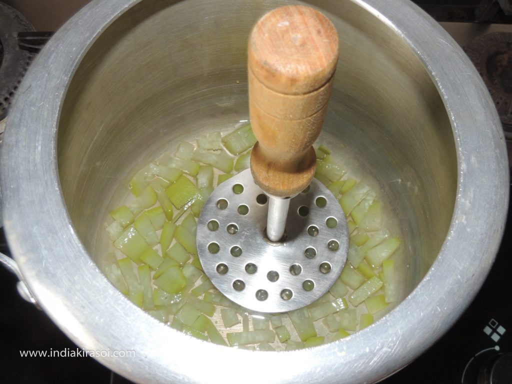Mash the Bottle gourd with a masher.