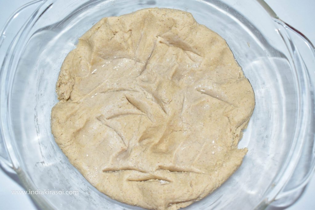 Make a few holes in the dough and sprinkle few drops of water in it.