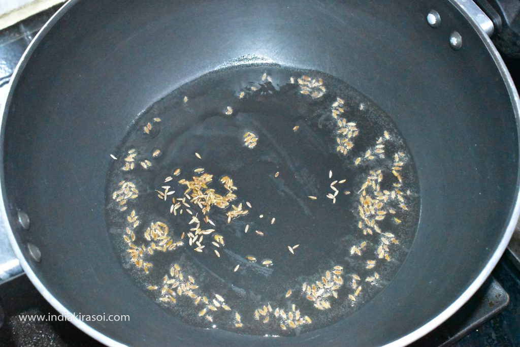 When the oil is hot, then add cumin seeds to the oil.