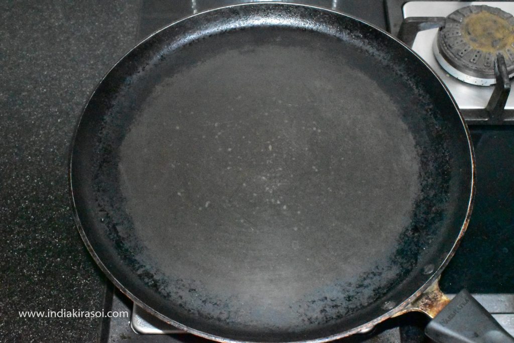 To make the paratha, put the griddle/ tawa on the gas.