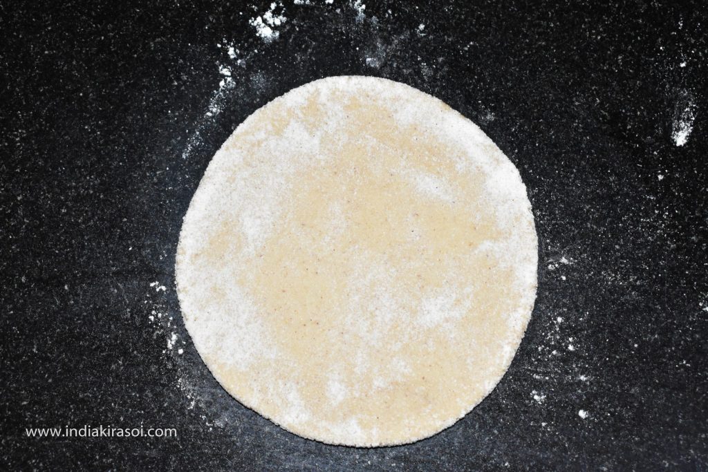 After this, apply a little flour dust on the dough and roll it to make 4 inch disc.