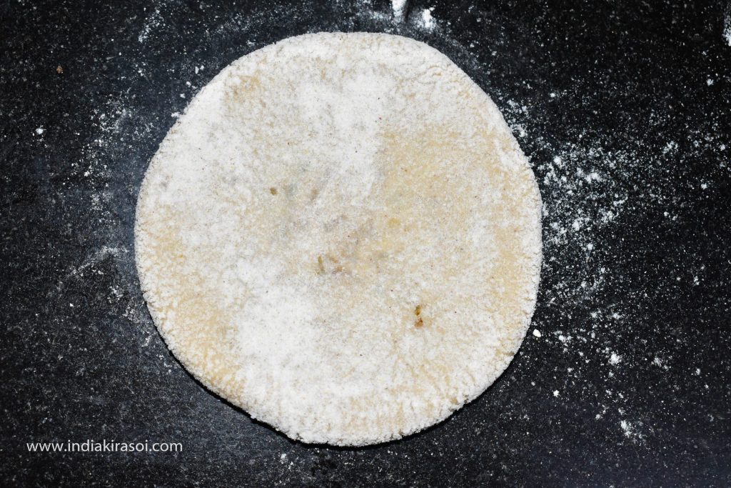 Wrap more flour dust around the dough so that the parathas can be rolled well.