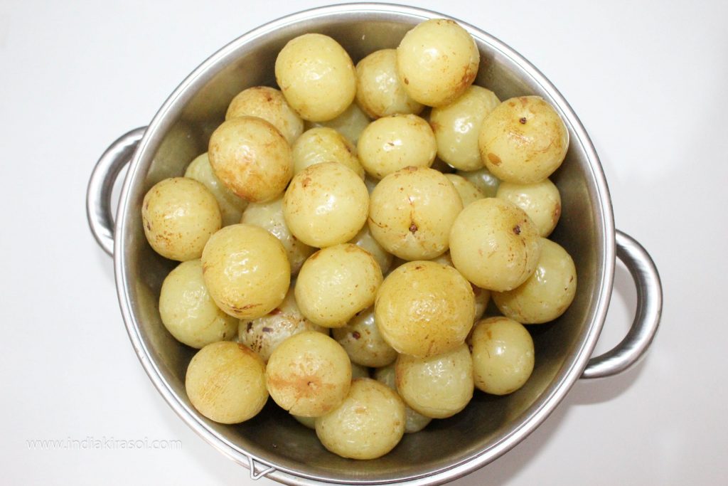 After 15 minutes, take out the amla/gooseberry with water and keep it aside.