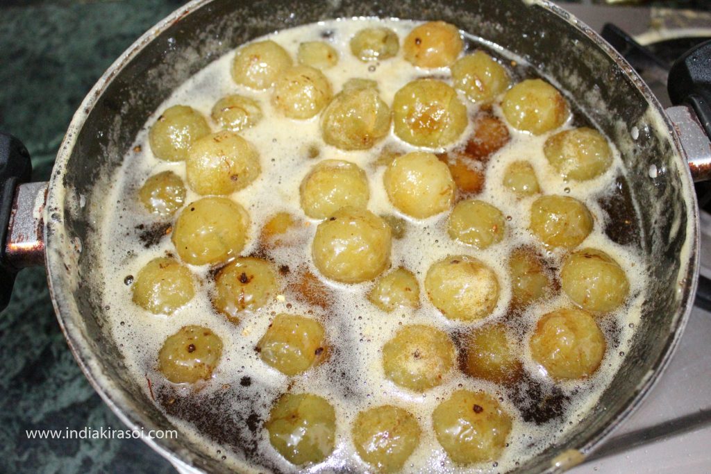 Heat syrup until one string of syrup formed, then put the amla/gooseberries in the syrup and let the amla cook for 5 minutes<span class="wprm-timer" data-seconds="300"></span> on low flame.