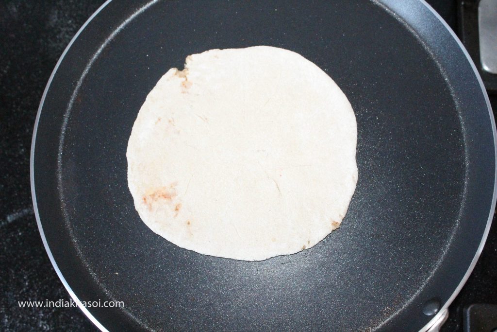Now put the paratha on the griddle.