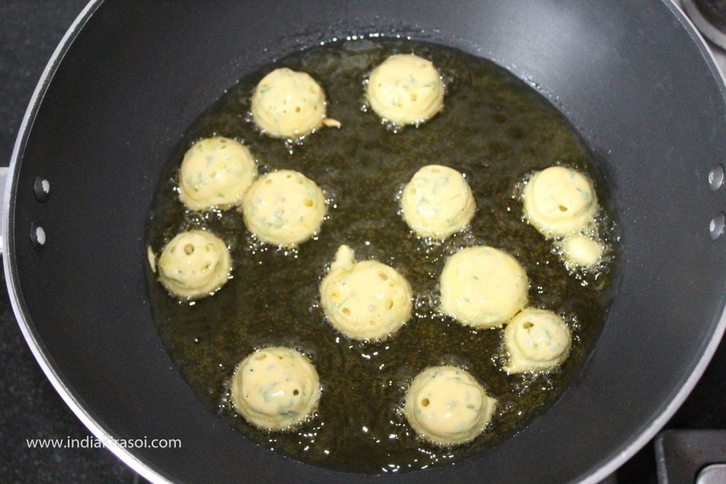 When the oil is hot, drop round-shaped pakora's/dumplings to the oil.