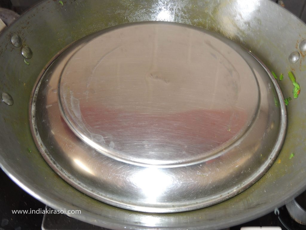 Cover the kadhai/fry pan with a plate.