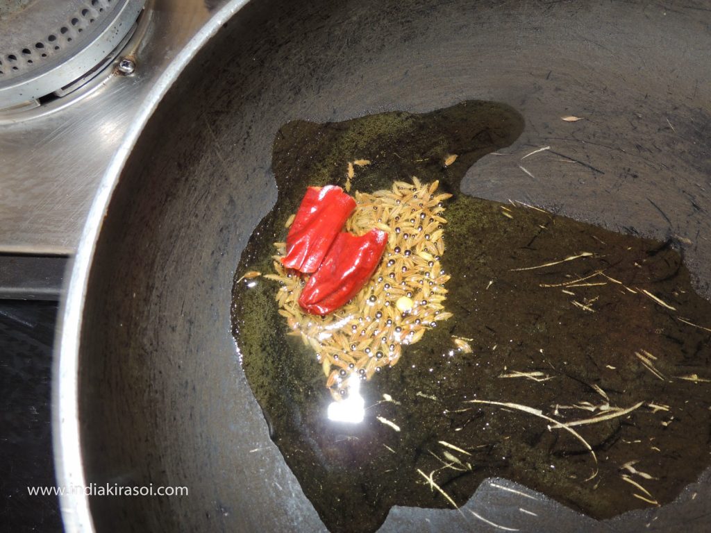 When the oil is hot, add half a teaspoon of cumin seeds to the oil.