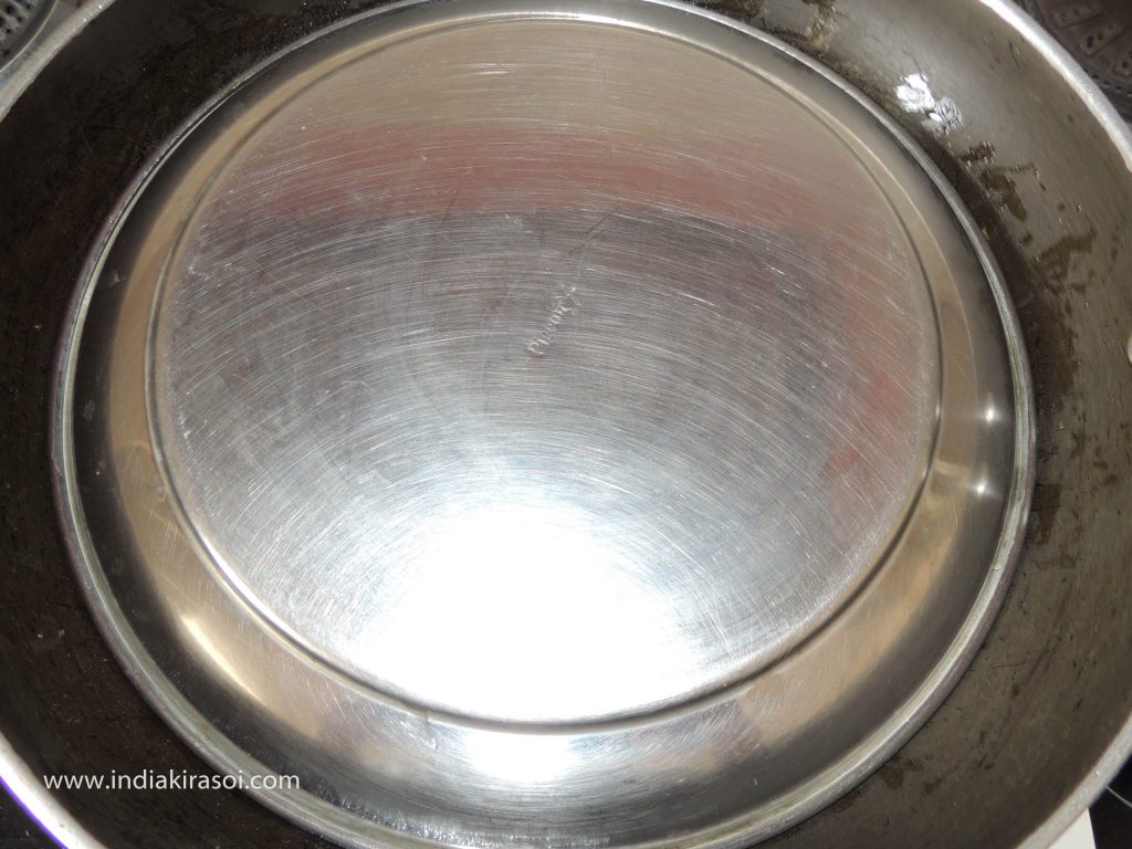 Cover the plate on the kadhai/fry pan.