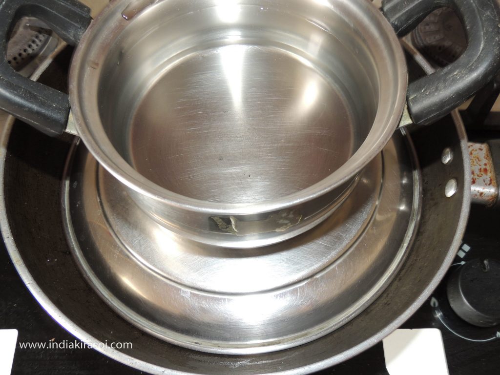 Put a heavy vessel on the kadhai/ fry pan. If there is no heavy vessel, then fill water in a vessel and place the pot of water on the plate of the kadhai/ fry pan.
