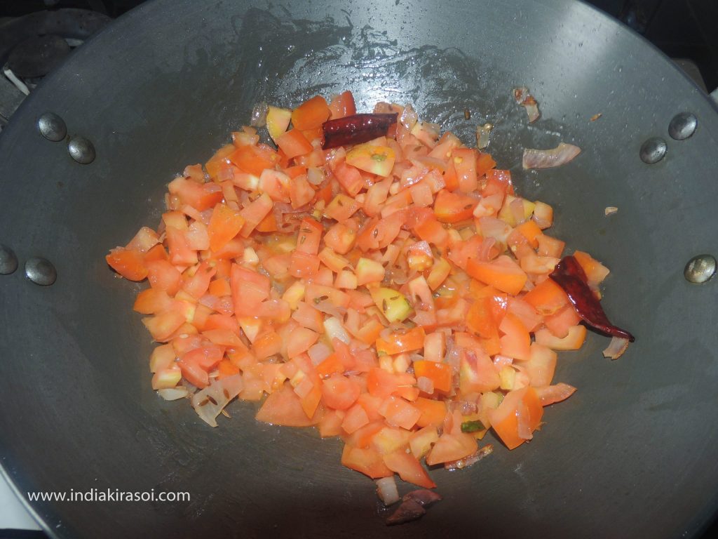 Then add chopped tomatoes to the kadhai/ fry pan.
