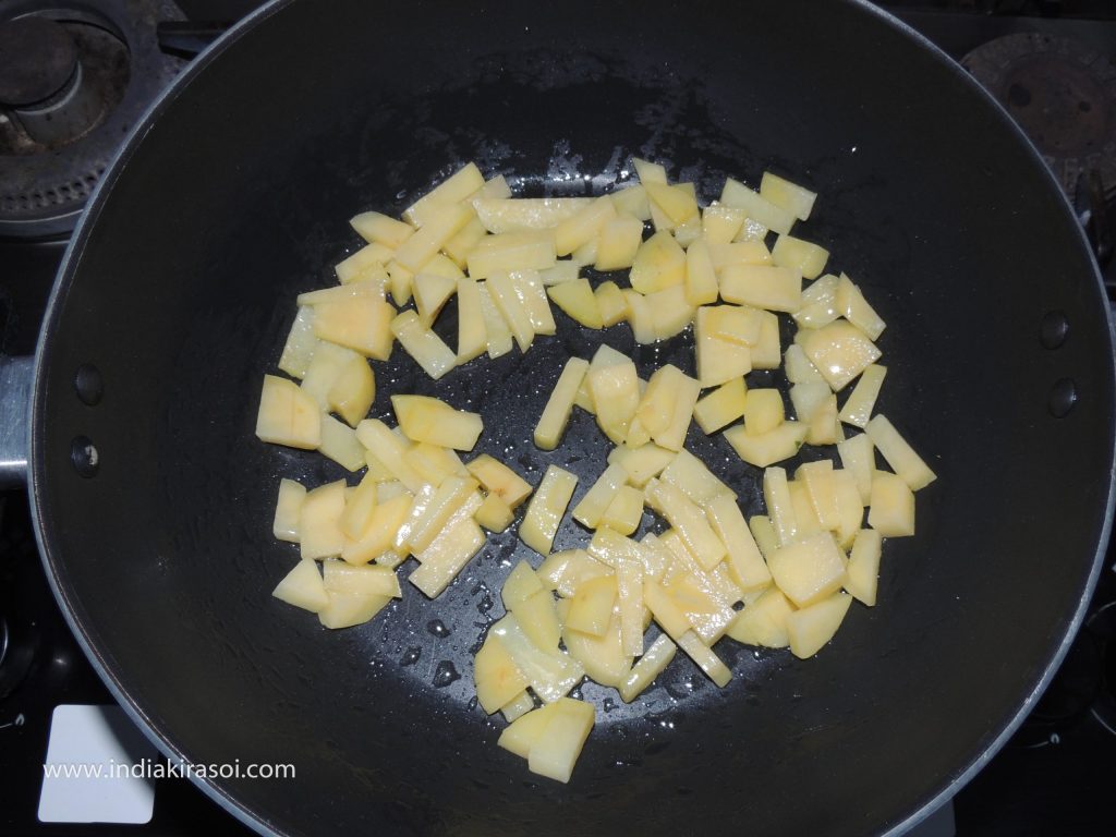 Put the chopped potatoes in the kadhai/ frying pan, keep the flame on medium.