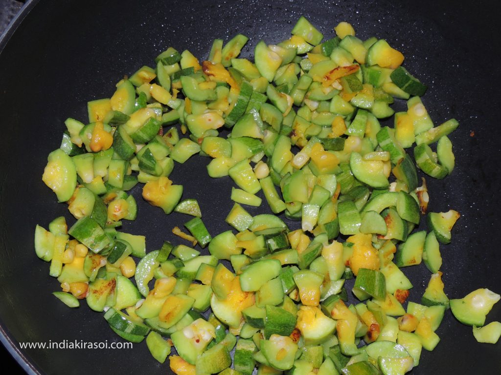 After frying the pointed gourd/ parwal, keep the pointed gourd/ parwal aside in a plate.