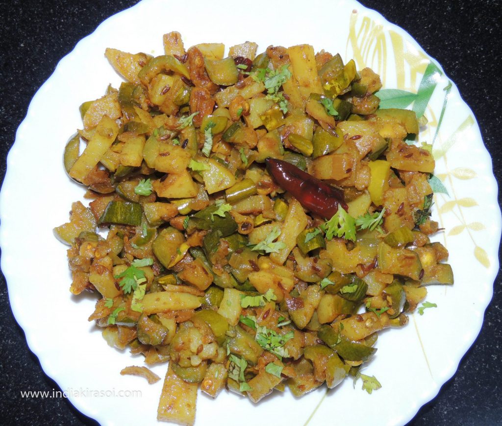 Add chopped coriander to the recipe of parwal potatoes.