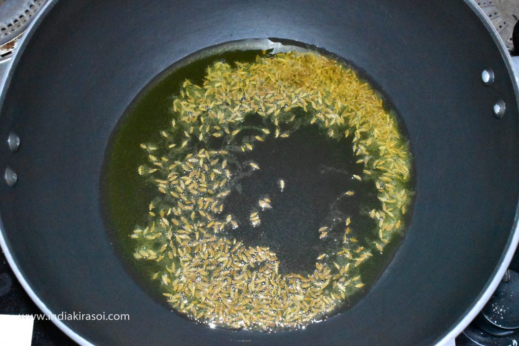 When the ghee becomes hot, add one spoon cumin seeds to the ghee.