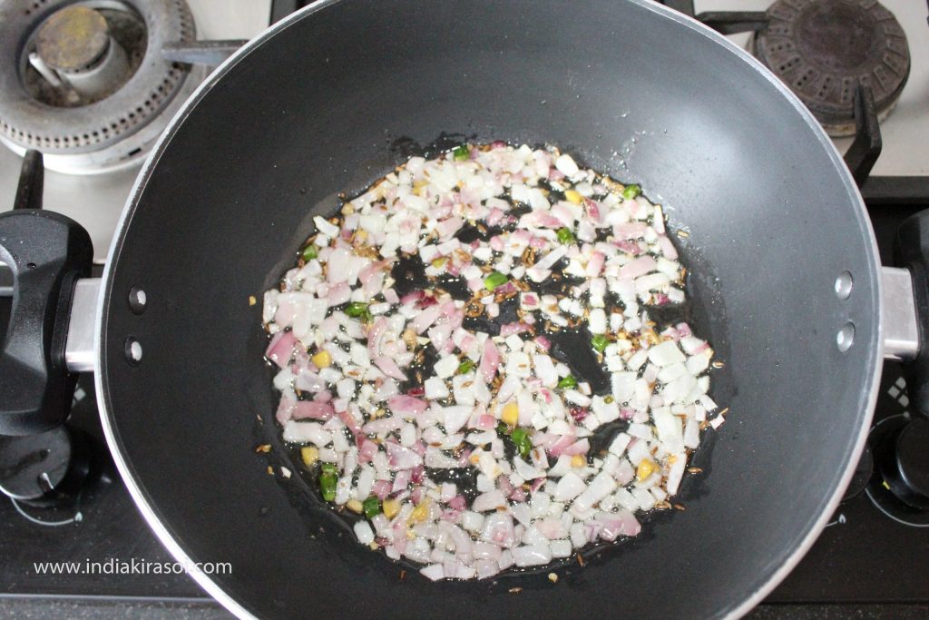 Fry the onion until it turns pink.