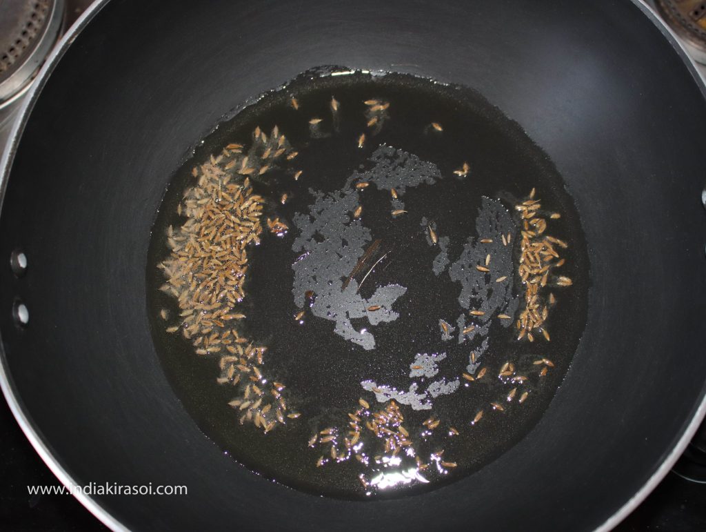 Put one spoon of cumin/ jeera seeds in the kadhai/ fry pan.