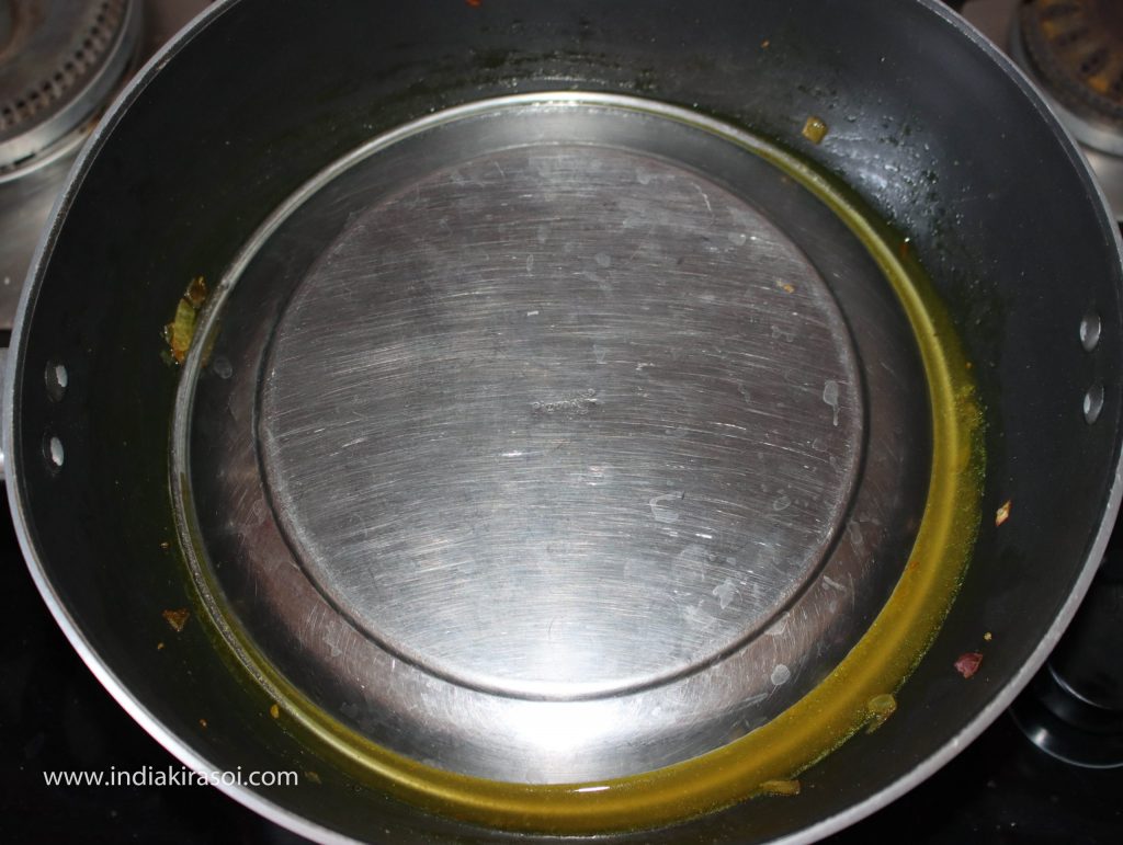 Cover the kadhai/ fry pan with a plate.