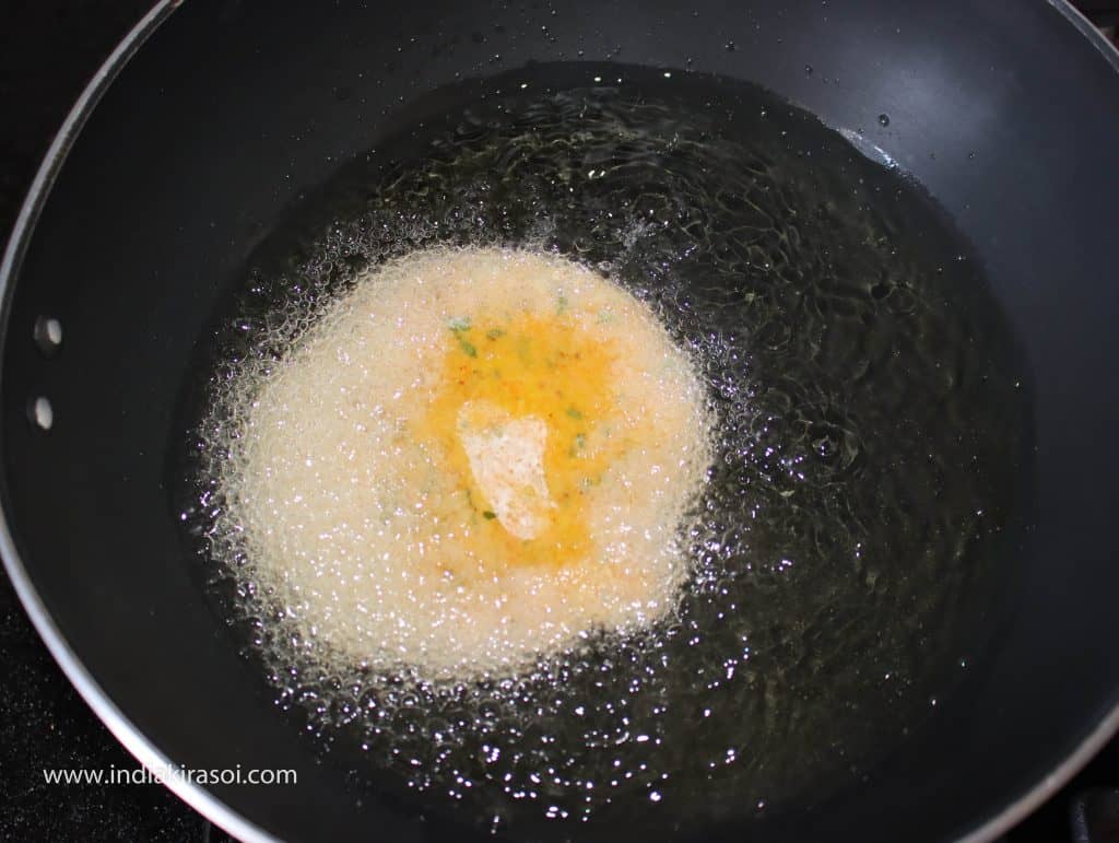 When the oil is hot, place rolled poori in the oil kadhai/fry pan.