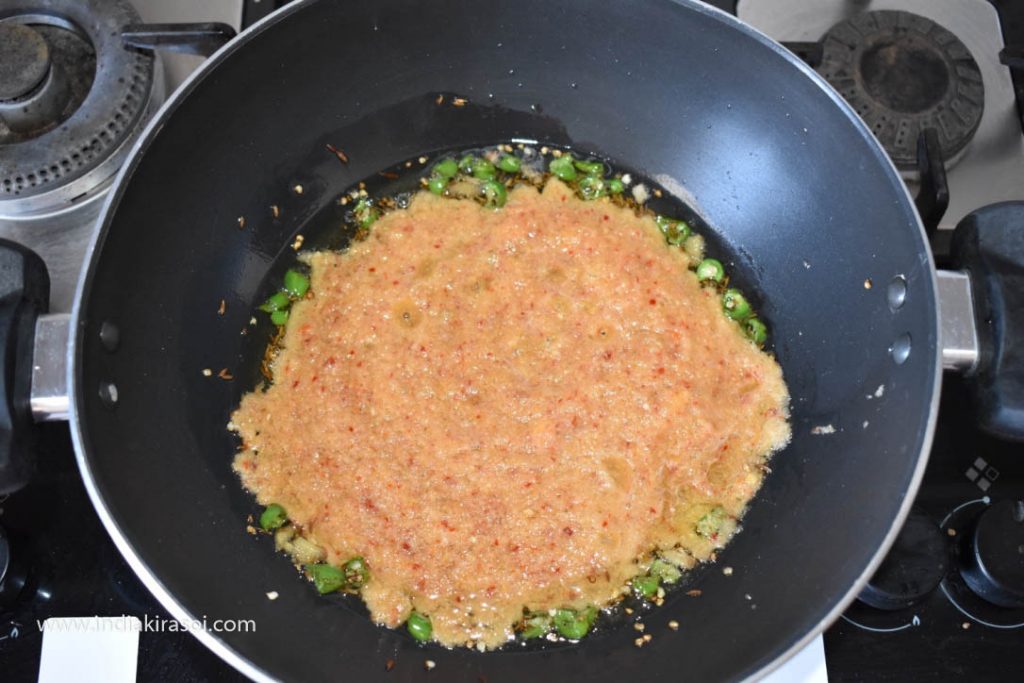 Then add the grinded spices in the kadhai/ fry pan.