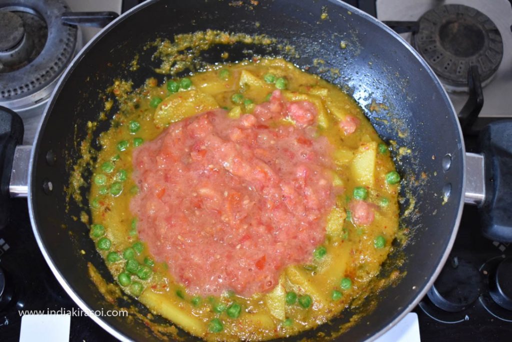 Remove the plate after 5 minutes, add the ground tomatoes in the kadhai/ fry pan.